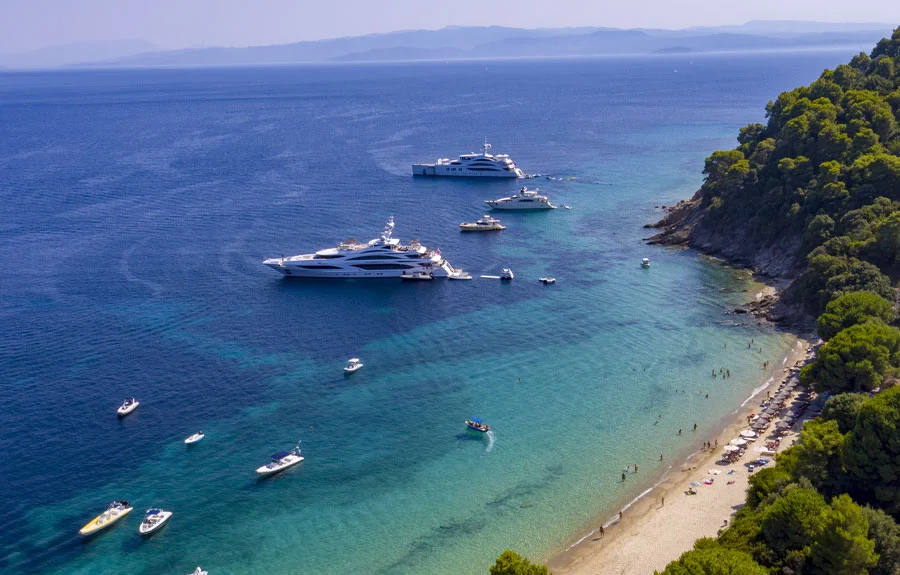 Yachts anchored beside a beach in Skiathos